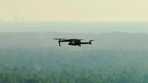 Cinematic Drone Orbit Small Spy UAV Over Forest Horizon in Military Context Vidéo 327468888