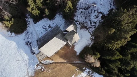Cinematic Drone Orbiting Above Isolated Mountain Chapel with Snow-Capped Stock Footage 331941706