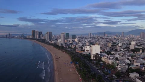 Cinematic Drone Pan of Da Nang Beach and Modern City Skyline at Sunrise Stock Footage 341264830