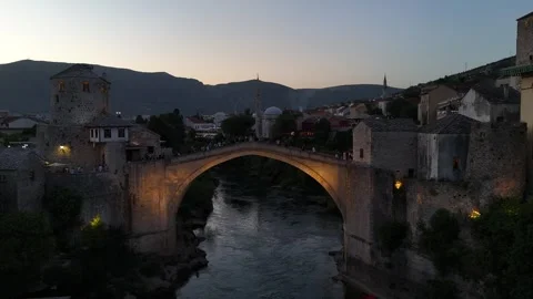 Cinematic Drone Pull Back From Lit Up Stari Most Bridge With Passing Boat Dusk Stock Footage 337830935