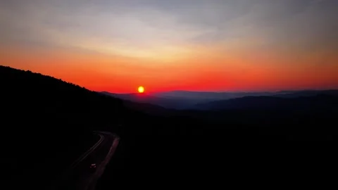 Cinematic Drone Pull Back Over Forest Road at Sunset No Cars 4K Footage Stock Footage 336493938