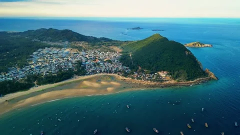 Cinematic drone pull back of Tan Phung bay with moored fishing boats 4K Stock Footage 339378421