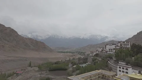Cinematic Drone Pull Out of Ladakh Monastery with Snow Covered Mountains with Vídeos de archivo 334656934