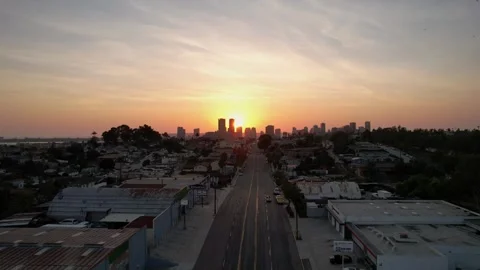Cinematic drone pullback from downtown skyline during sunset with birds flying Stock Footage 332687060