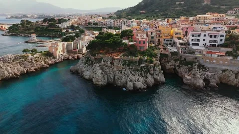 Cinematic drone pullback over pink villa on cliffside in Porticello revealing Stock-Footage 310347995