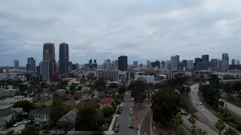Cinematic drone pullback revealing the San Diego skyline at 7PM during dusk Stock Footage 333280229
