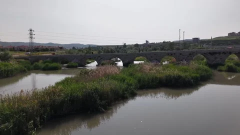 Cinematic Drone Push-In Toward Historic White Stone Bridge Over River Stock-Footage 336332507