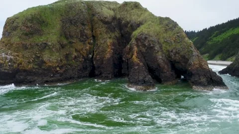 Cinematic drone rises from ocean level to orbit two hikers atop Bird Rocks off Stock Footage 341095762