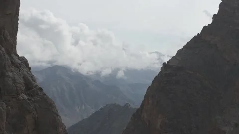 Cinematic Drone Shot Between Mountains Revealing Layered Himalayan Peaks in the Vídeos de archivo 334655517