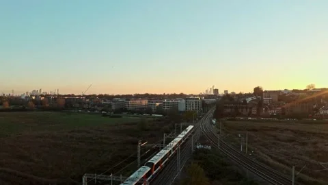 Cinematic drone shot of class 710 London overground train heading towards Stock Footage 166076970