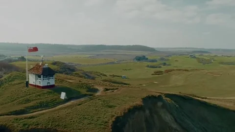 Cinematic drone shot drifting over rolling green hills in the English Vídeo Stock 335390743