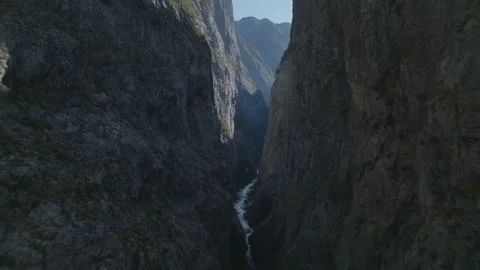 Cinematic drone shot flying through a narrow mountain pass Stock Footage 322874117