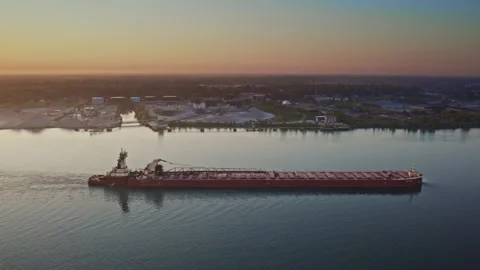 Cinematic drone shot of a freighter gliding along the river at daybreak. Stock Footage 317536192