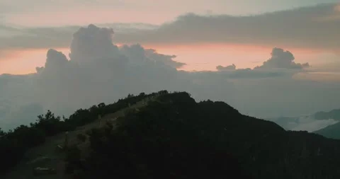 Cinematic Drone Shot of Mountain Range Above Fog During Sunset Indonesia Stock-Footage 331708516