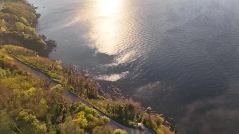 Cinematic Drone Shot Moving Over Lighthouse to Reveal Sun and Foggy Sea 스톡 동영상 339328494
