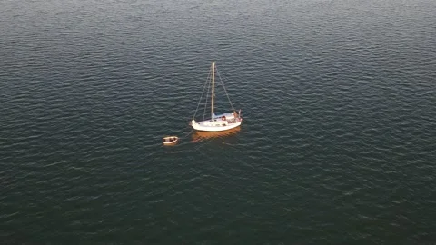 Cinematic Drone Shot Sailboat Anchored in the Outer Banks Golden Hour Stock Footage