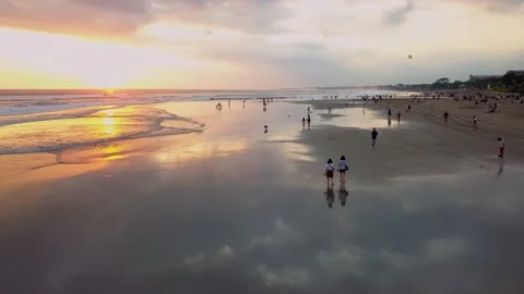 Cinematic drone shot. Sunset over ocean waves wash sand beach. Aerial sunset 스톡 동영상 222010143