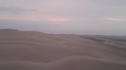 Cinematic drone shot of a sunset over a tranquil desert landscape Stock Footage 299954907