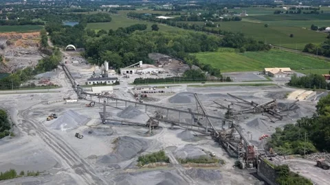 Cinematic drone shot sweeping over an active stone quarry pit, excavation site Video stock 344955618