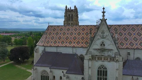 Cinematic drone side view of Royal Monastery of Brou, France, colorful tiled roo 库存影片 332054063