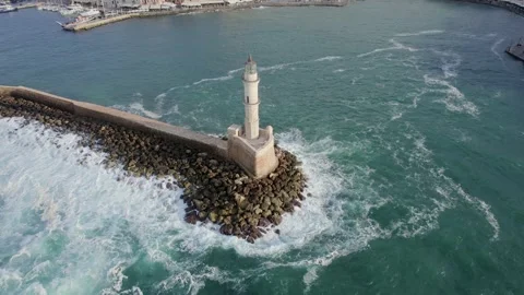 Cinematic Drone sunset shot. Waves breaking on lighthouse rocks. Video stock 168254371