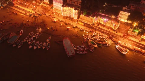 Cinematic drone view of Assi Ghat, Banaras, glowing with diyas and lights d.. Stock Footage 347449801