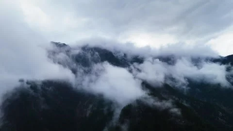 Cinematic Drone View of Clouds Drifting Over a Mountain Valley 4K Stock Footage 331265407