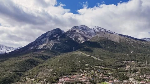 Cinematic Drone View of Mountain Peak Under Cloudy Sky Stock Footage 332059632