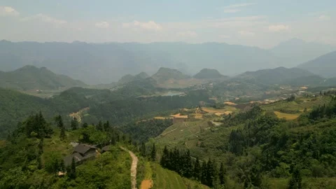 Cinematic drone view over a valley in Ha Giang Vietnam with rice fields Video stock 313797580