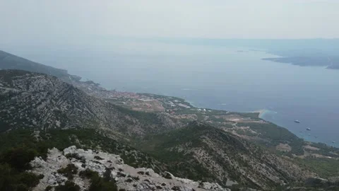 Cinematic drone view of Peninsula on Brac Island in Croatia - Bol city Video stock 231383204