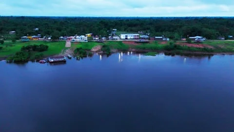 Cinematic Drone View of a Remote Riverside Community Beside Still Water Stock-Footage 332537294