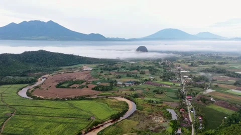 Cinematic drone view of a winding river flowing across green agricultural fields Stock Footage 346012255