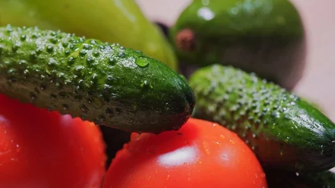 Cinematic drops fall and flow down on cucumbers and tomatoes, MACRO. Organically Stock Footage 125771548