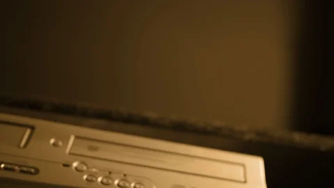 Cinematic DVD player ejects a disk with depth of field - Sepia old technology ve Vidéo 90104089
