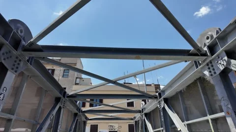 Cinematic dynamic video shot capturing a modern urban pedestrian metal bridge Stock Footage 341426636