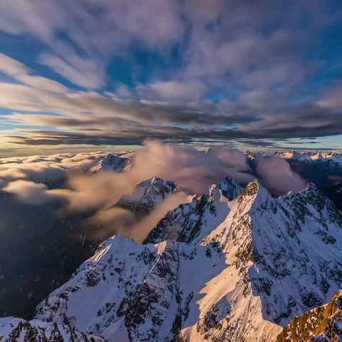 Cinematic Establishing Shot of Mountain Range with Rolling Clouds Stock Footage 302184696