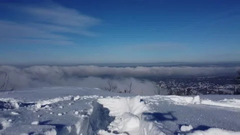 Cinematic fast motion fly over edge of snowy Mount Beacon cliff with city pan Stock Footage 158171304