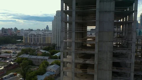 Cinematic flight around the building under construction in the center of the 스톡 동영상 113581734