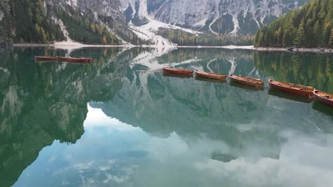A cinematic flight over a beautiful alpine lake surrounded by mountains Stock Footage 257466746