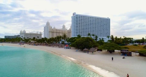 Cinematic fly down from  high rise level till low water/white beach. Stock-Footage 104888496