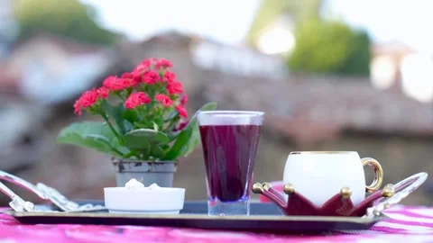 Cinematic Focus Pull From Rustic Stone Village to Traditional Turkish Coffee Stock Footage 323403501