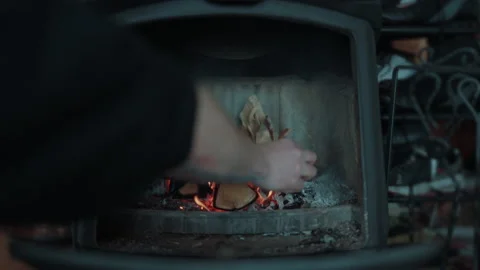 Cinematic Footage of Loading an Old Norwegian Fireplace with Firewood and Stock Footage 237243654
