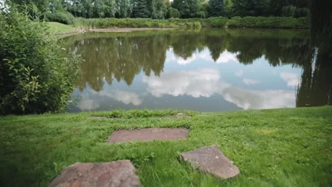 Cinematic forward camera movement along natural stone path leading to a lake 스톡 동영상 326467446