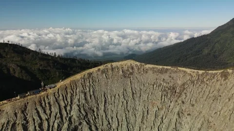 Cinematic Forward Drone Flight Over Ijen Crater Ending with Pan Down to Green Fi Stock Footage 260039934
