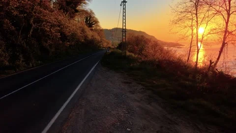 Cinematic Forward Motion Along Empty Coastal Road at Golden Sunset Stock-Footage 339384792