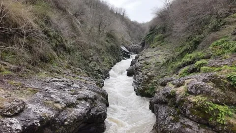 Cinematic Forward Movement Over Muddy River in Canyon 4K Nature Scene Video stock 334425475