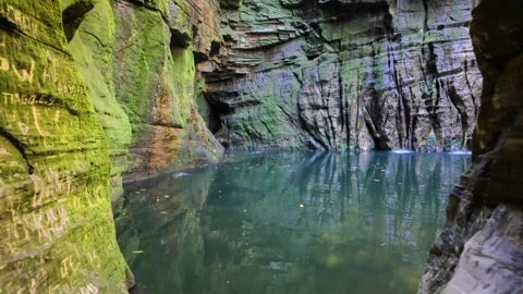 Cinematic forward movement revealing a hidden tropical cave waterfall Stock Footage 340276635
