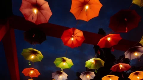 Cinematic forward moving shot under decorative umbrella in street festival 動画素材 344781564