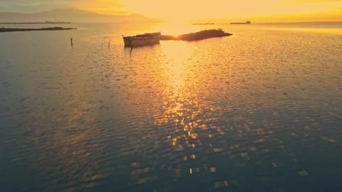 Cinematic forward tracking over tranquil wetlands water and yellow boat Stock-Footage 345977341