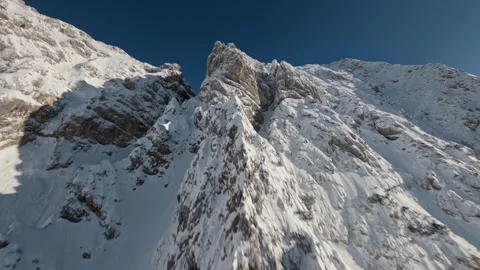 Cinematic FPV Cloud Surfing Fresh Snow Alpine Ridge, 4K Stock Footage 323465508